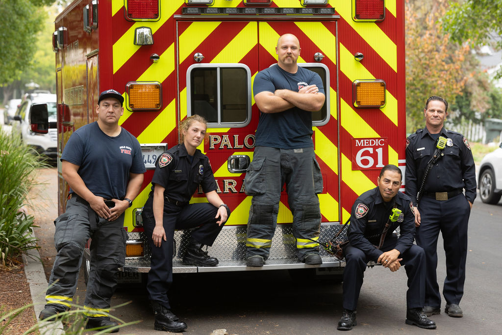 Crew posing on the back of an ambulance
