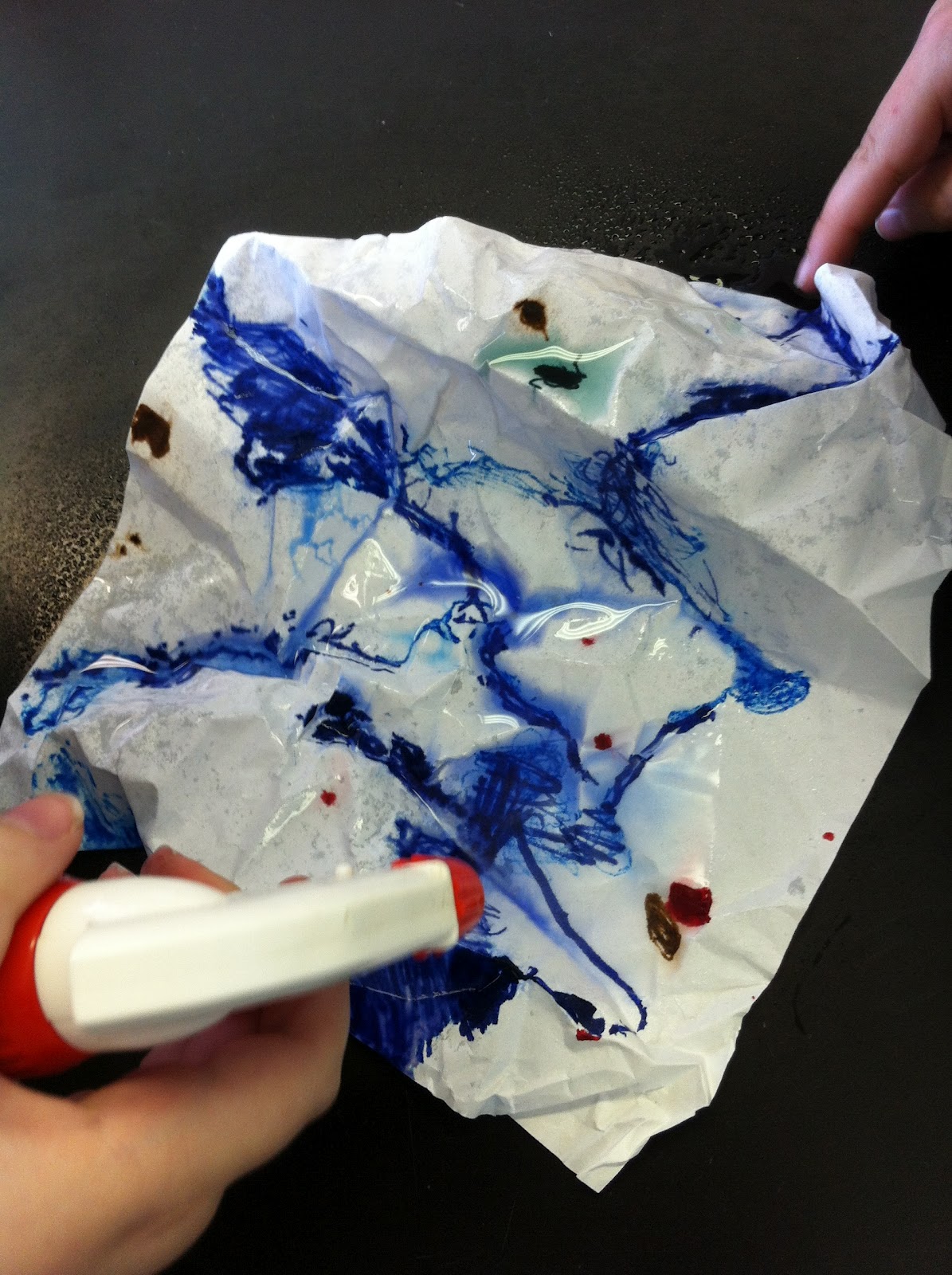 paper model of a watershed with ink bleeding due to sprayed water