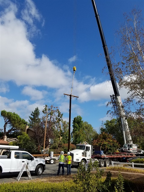 truck pulling a pole