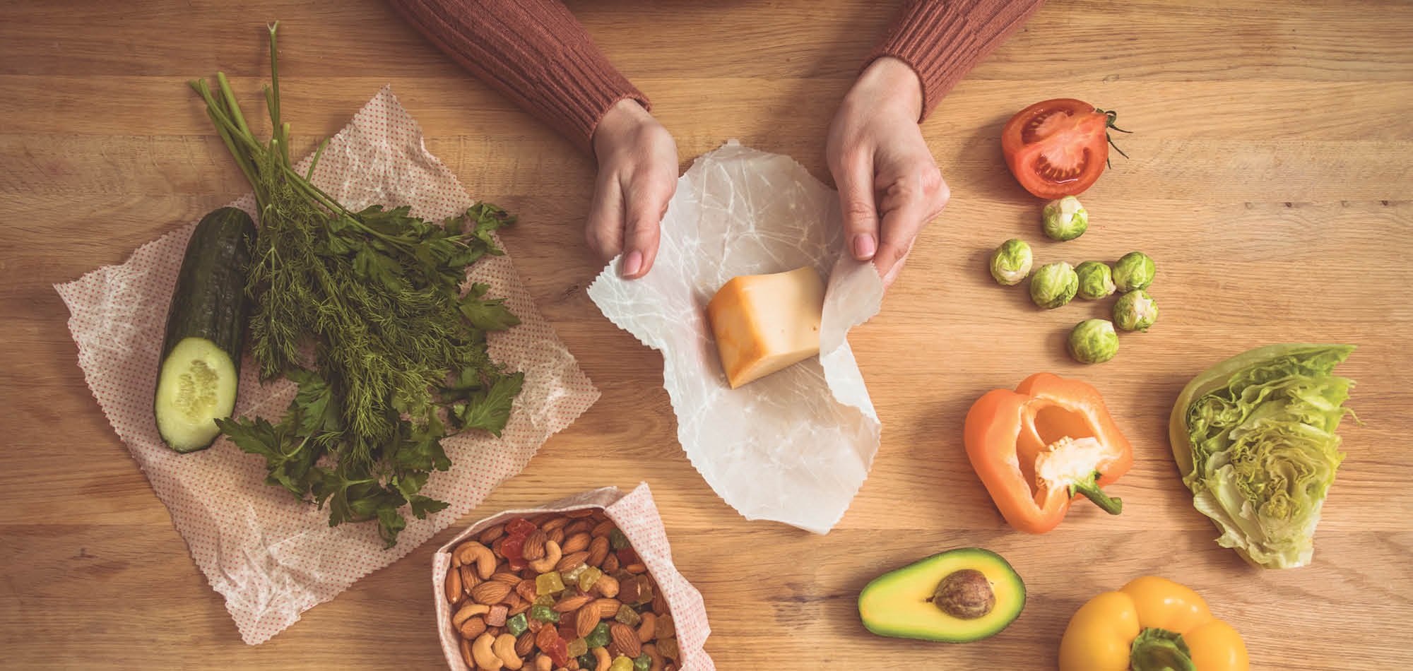 person placing cheese into Beeswax Wrap
