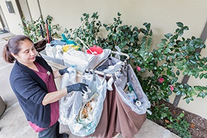 Dinah's Hotel staff using cart equipped with 3-sort refuse collection bags