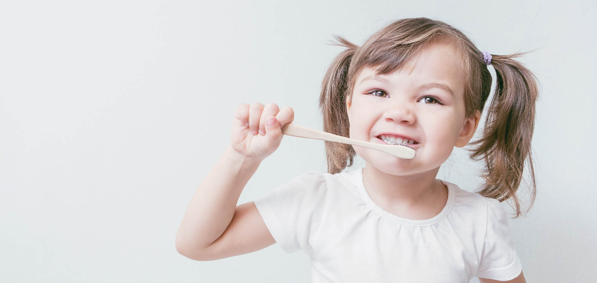 Girl brushing her teeth with Fiber Toothbrush