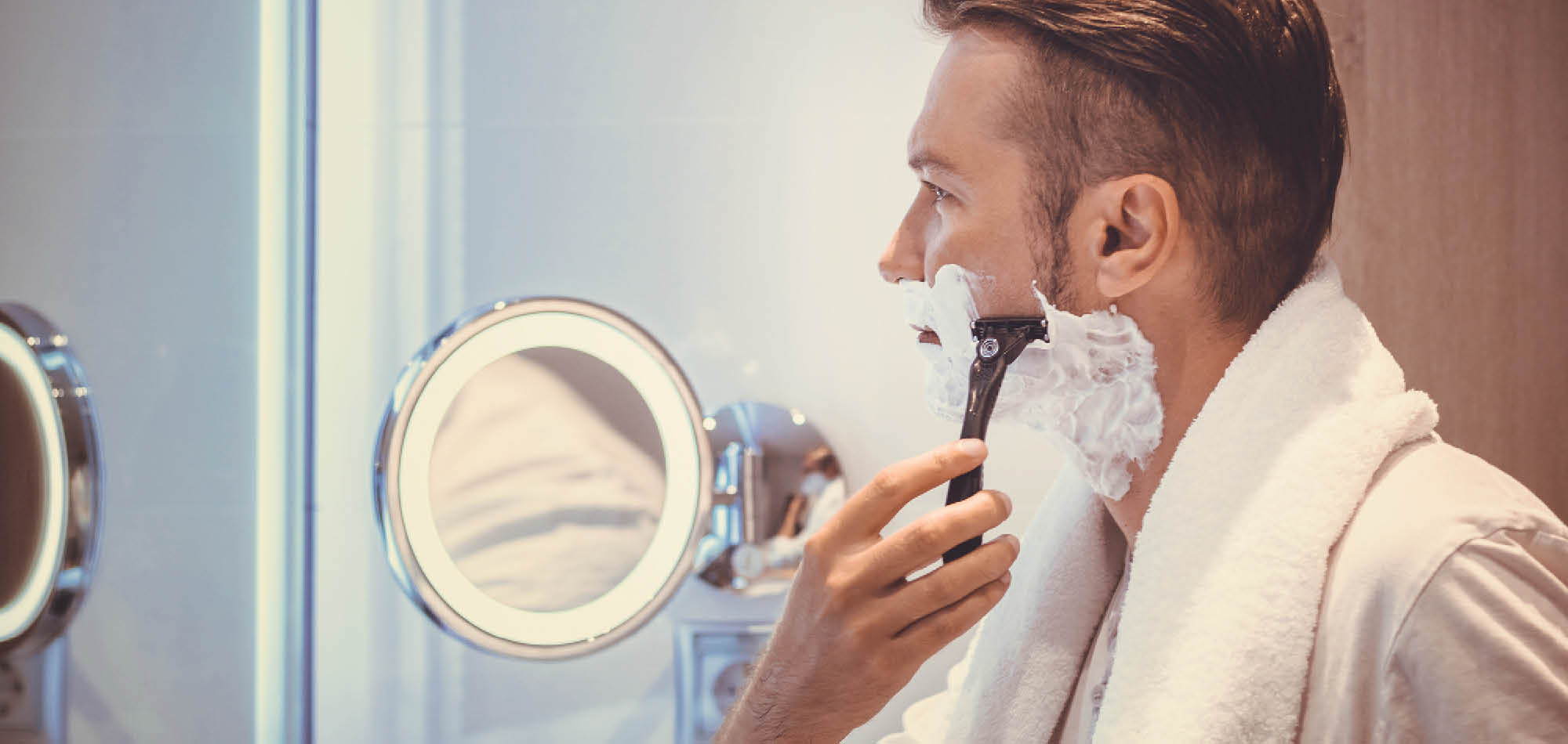 man shaving face with reusable razor