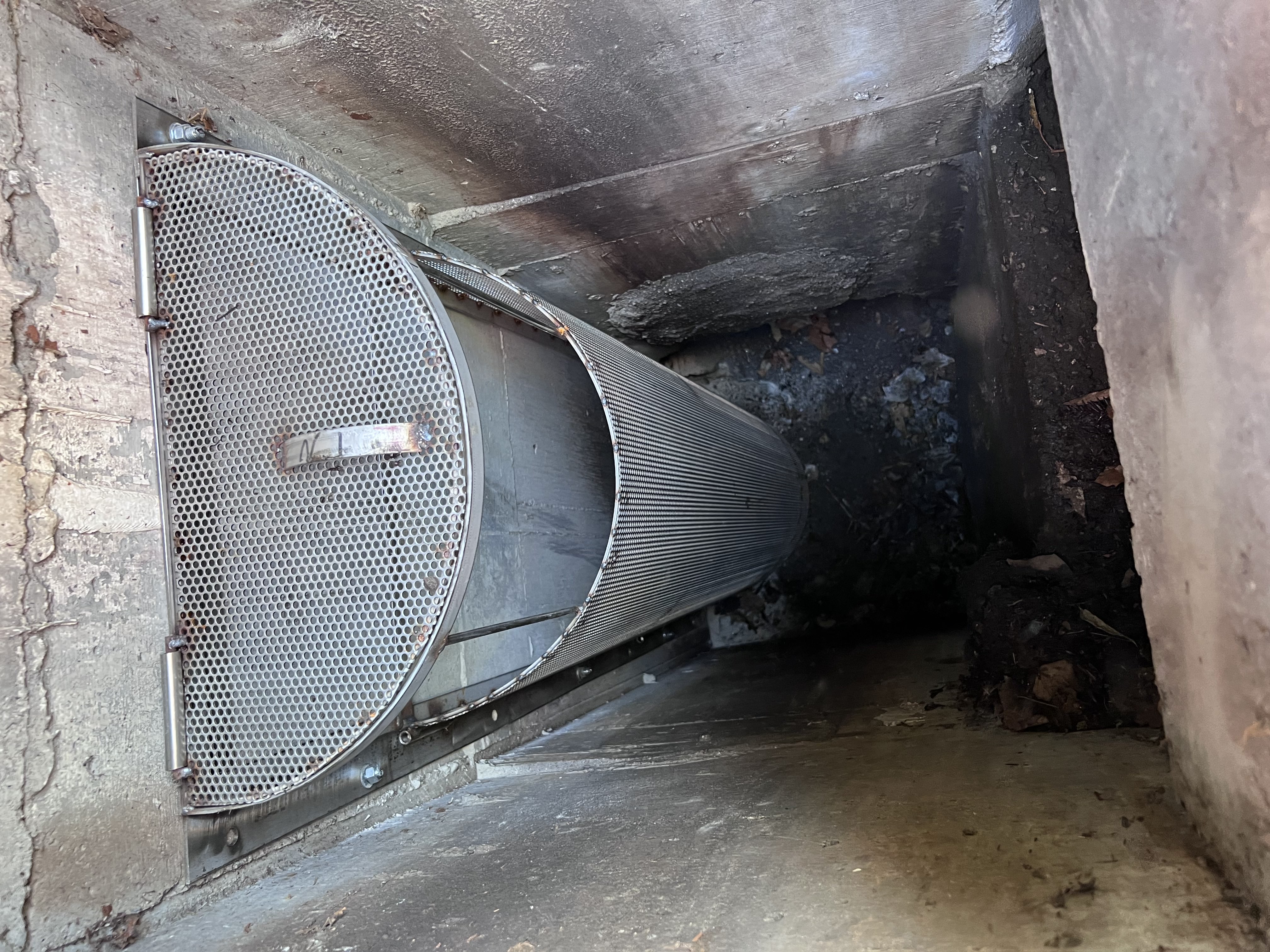 Example of small capture device in a storm drain inlet.