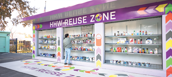 Person taking items from the HHW Reuse Zone 