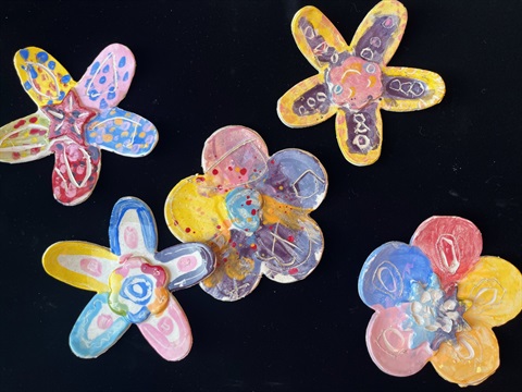 photograph of colorful ceramic flowers on a black background