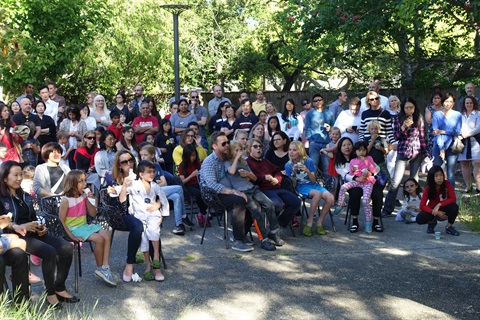 crowd of people gathered in the Art Center's Sculpture Garden for the Youth Art awards