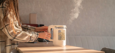Person holding an electric kettle